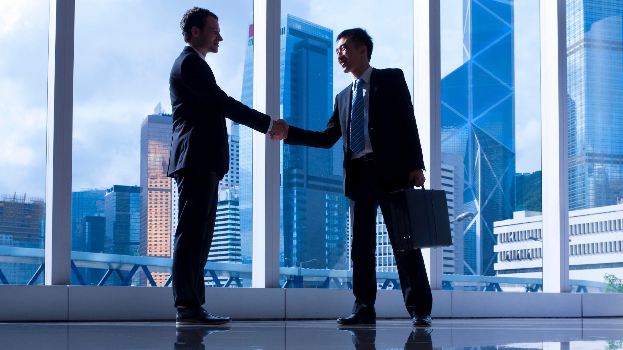 Business partnership discussion in a modern Singapore setting