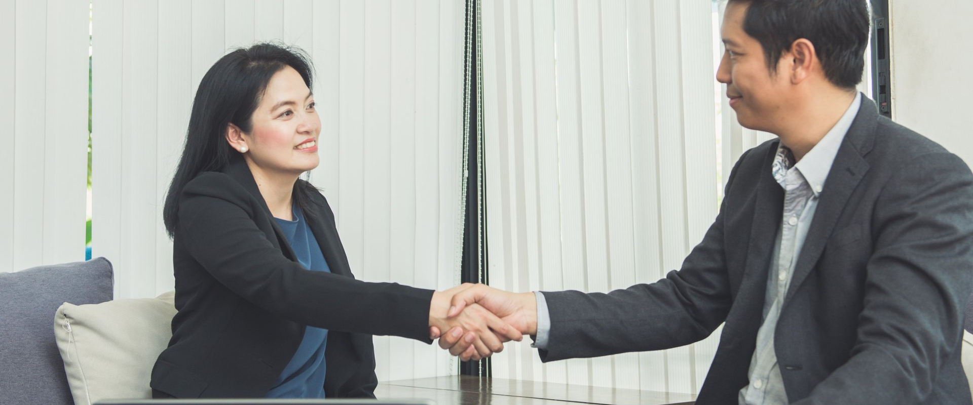 Business partnership discussion in a modern Singapore setting